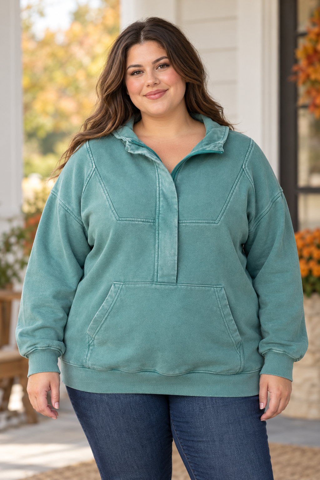 Model wearing a teal Michelle Mae vintage-wash pullover with a collared half-button placket and a kangaroo pocket
